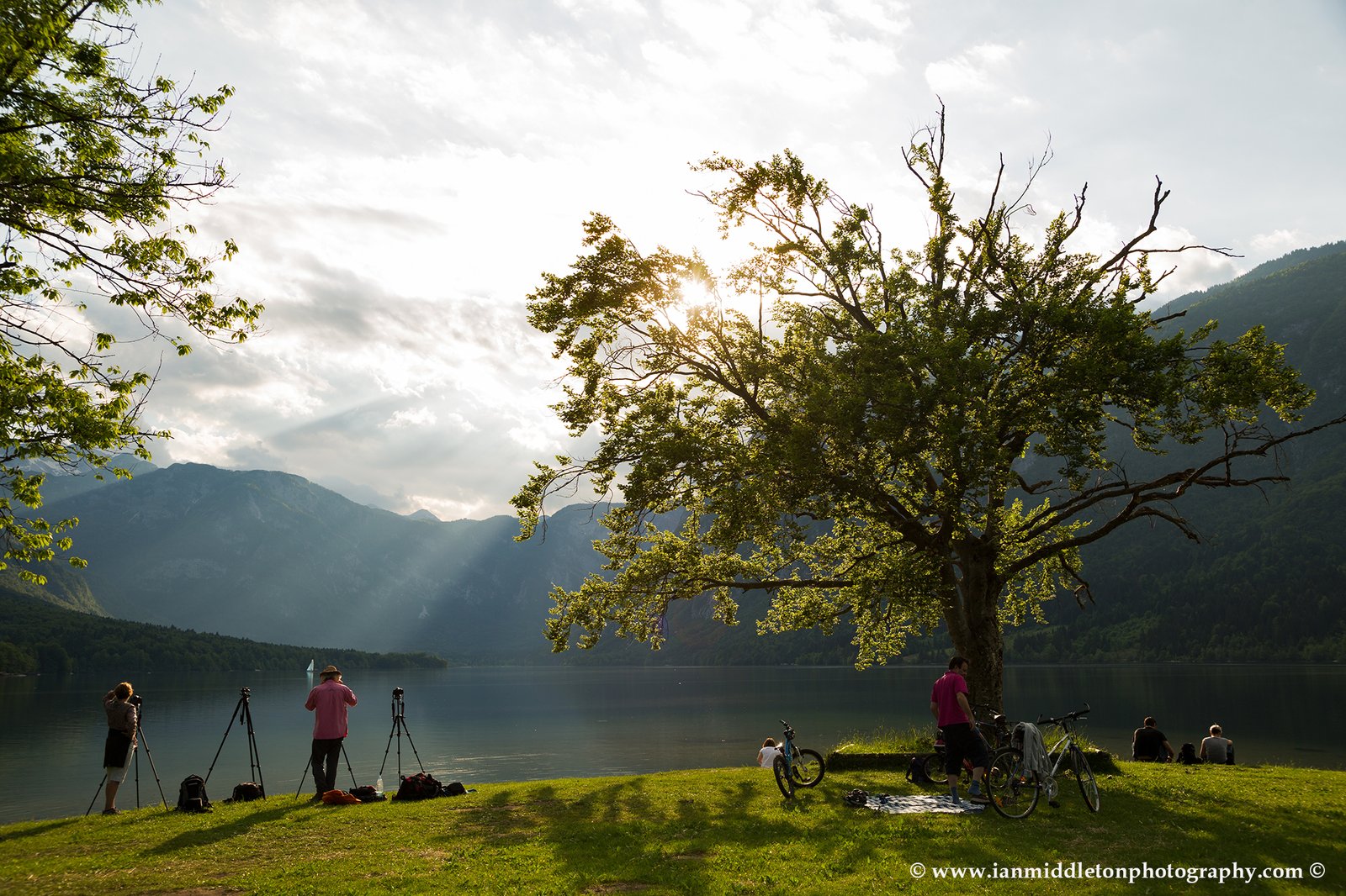 Workshop participants photographing beautiful light and clouds scattering over Bohinj Lake,Triglav National Park, Slovenia.